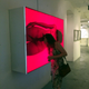 A visiting American peers into an artwork at la Fabrica de Arte Cubano.